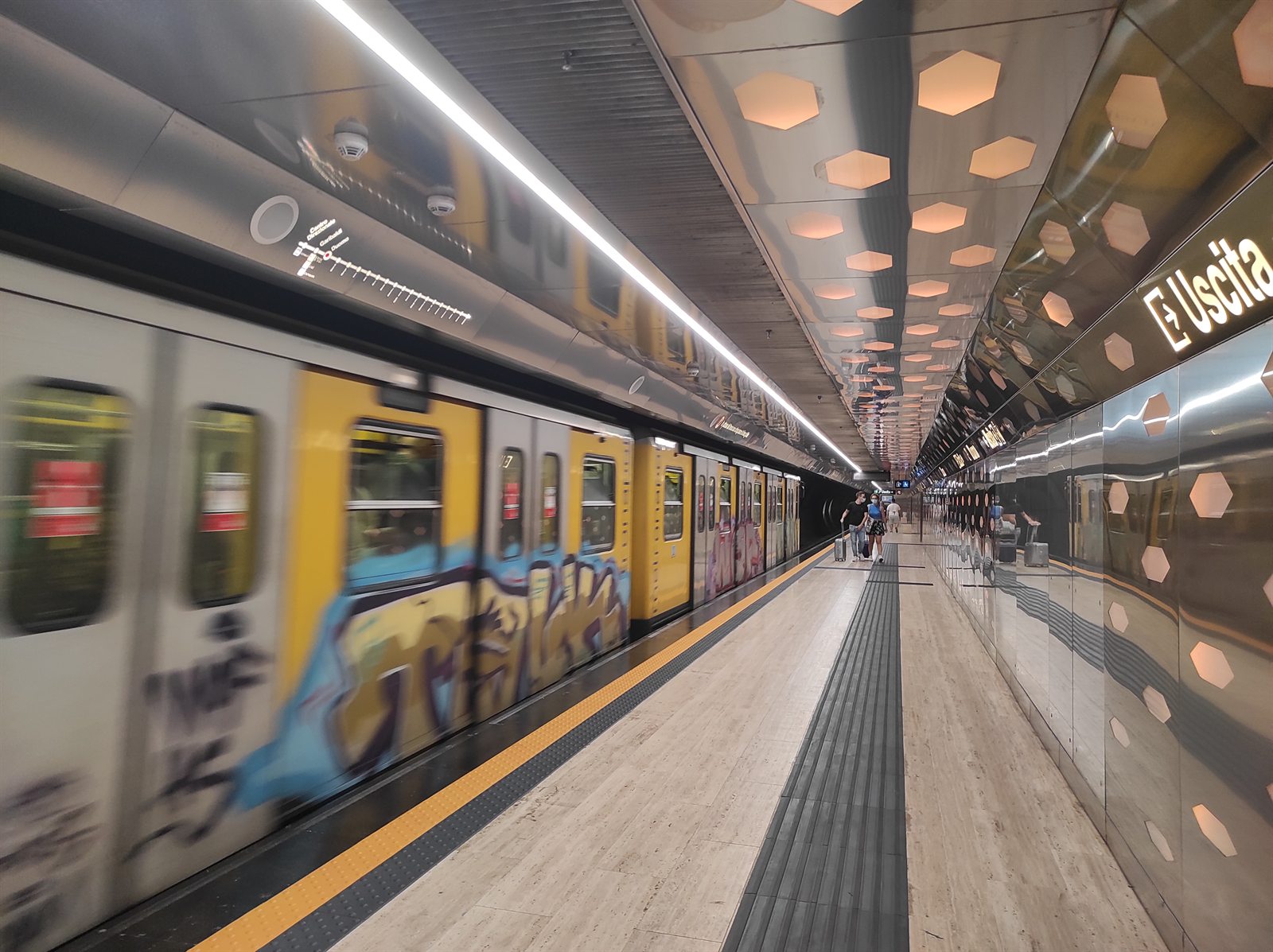 Real photograph of a train at the platform of Duomo station on Naples Metro Line 1